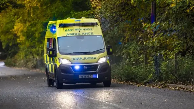 An ambulance on blue lights