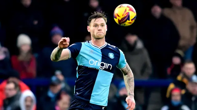 Wycombe defender Joe Low keeps his eye on the ball