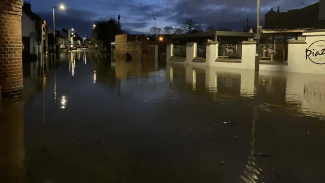 The scene along Quorn high street showing high levels of flood water