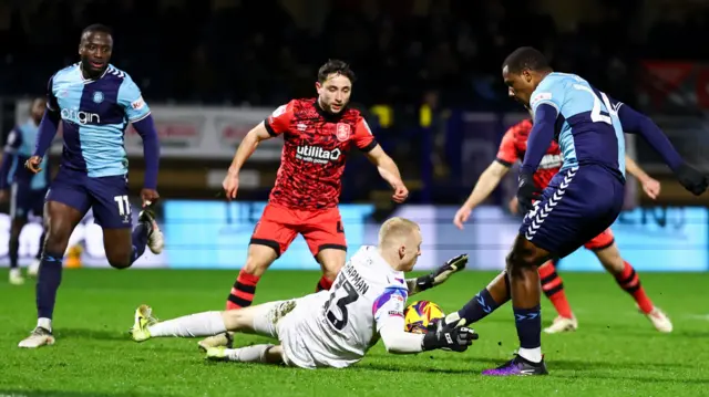 Wycombe striker Richard Kone is denied by Huddersfield keeper Jacob Chapman