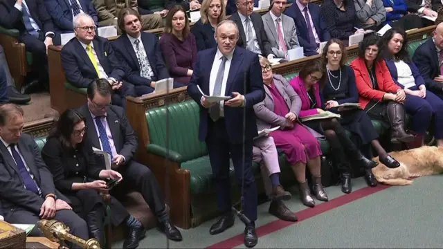 Ed Davey stands on the floor of the House of Commons as he asks his question to the PM