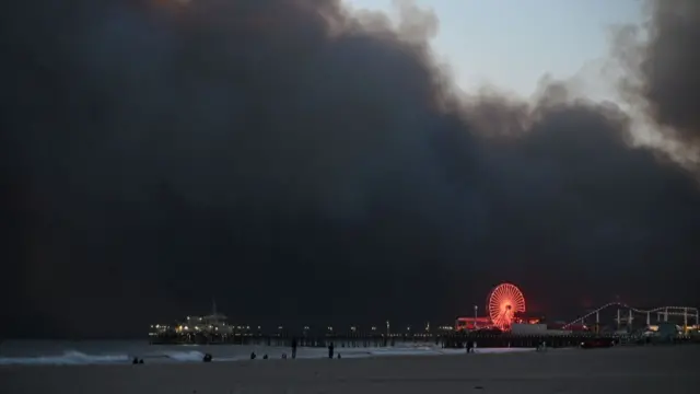 Smoke from the fire fills the sky as seen from Santa Monica Beach