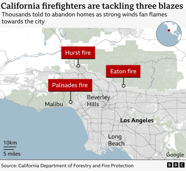 A map of Los Angeles, California, and the surrounding areas shows where three brush fires are burning. On the outskirts of LA in the north, there's the Eaton fire, to its west is the Palisades fire, and just north of the two making a triangular shape of the three is the Hurst fire.