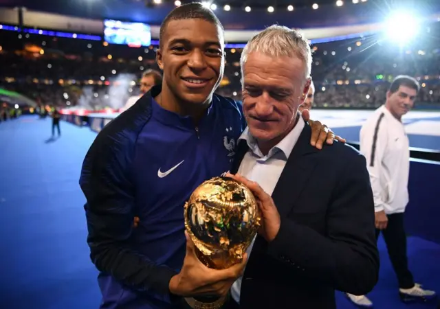 Kylian Mbappe and Didier Deschamps with World Cup trophy