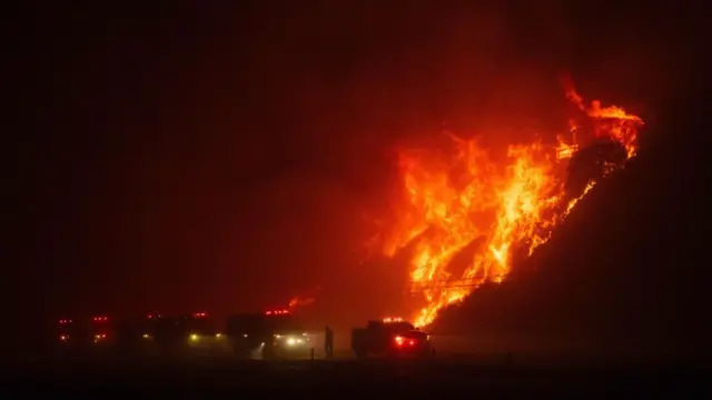 A home burns along a highway