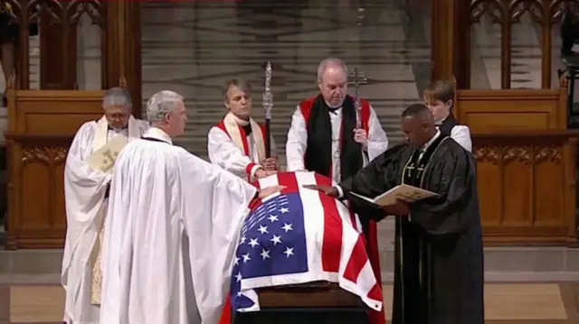 Clergy gathered around Carter's casket