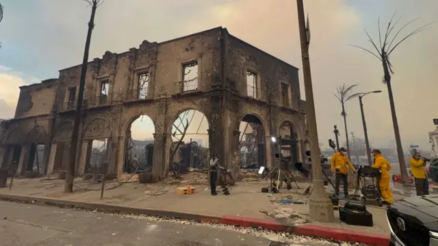 The burnt out structure of a shop stands on a devastated corner of Sunset Boulevard.