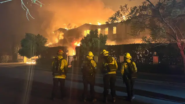 Firefighters trying to contain the fire at a Pacific Palisades neighbourhood