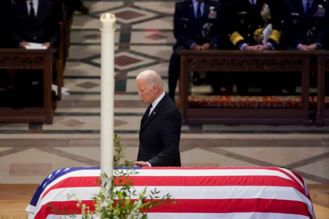 Joe Biden touches coffin