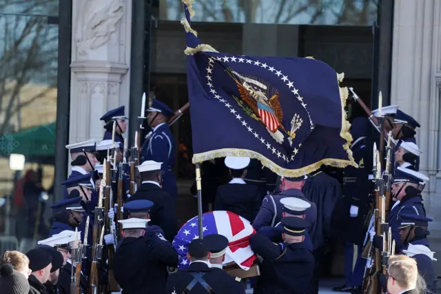 Members of honour guard carry Carter's casket into the cathedral