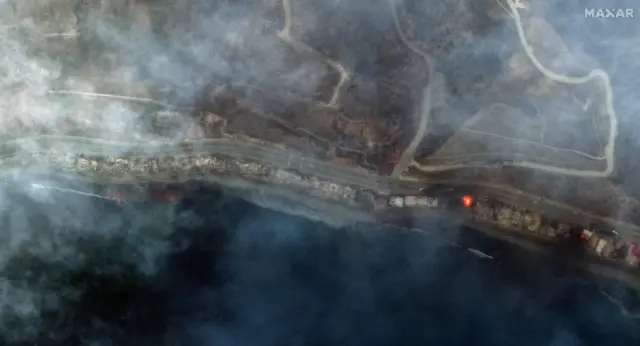 Satellite image of Pacific Coast Highway along the Malibu coastline with smoke covering the scene