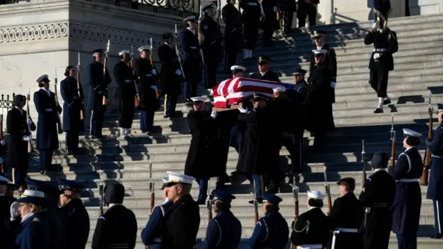 The flag-draped casket of President Carter was carried out by a joint military service honour guard down the steps of the US Capitol