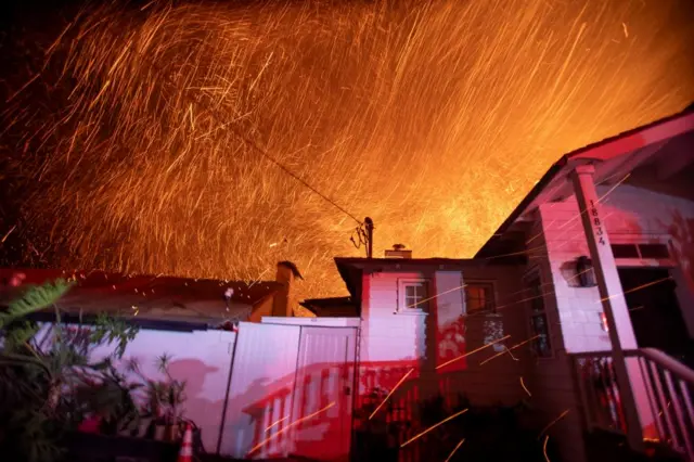 The wind whips embers as the Palisades fire burns during a windstorm