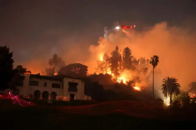 Flames rise from the Sunset Fire in the Hollywood Hills