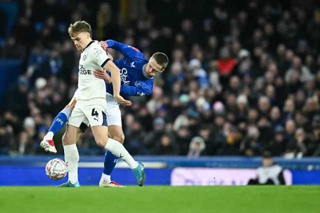 Archie Collins (L) fights for the ball with Everton's English midfielder #45 Harrison Armstrong