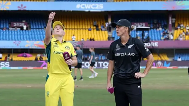 Alyssa Healy of Australia tosses the coin alongside Sophie Devine of New Zealand