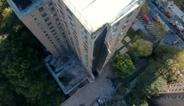 An aerial photo of a building with a missing chunk