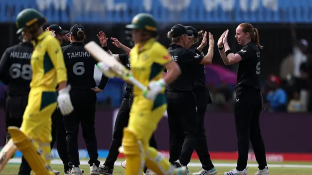 Bree Illing of New Zealand celebrates with team mate Sophie Devine after taking the wicket of Alyssa Healy of Australia