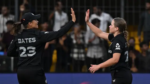 ess Kerr of New Zealand celebrates with team mate Suzie Bates after taking the wicket of Sophie Molineux of Australia