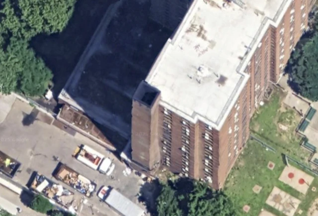 A residential building is seen from above. In the angle, you can see the chimney of the structure on the lower left side is still attached