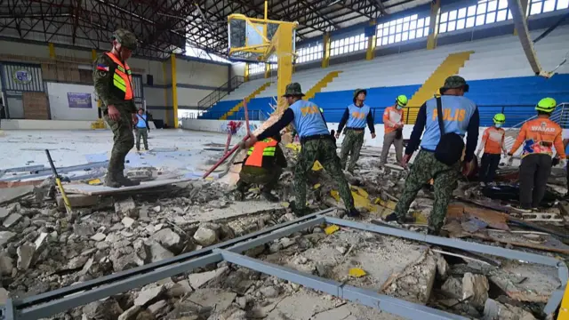 Rescuers inspect damage at the sports complex