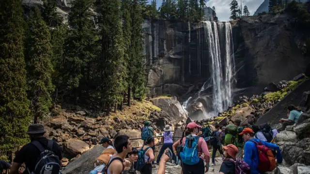 Visitors hike the Mist Trail toward Vernal Falls on August 31, 2025 in the Yosemite National Park, California.