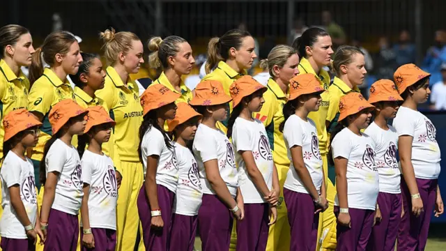 Players of Australia line up for the national anthems