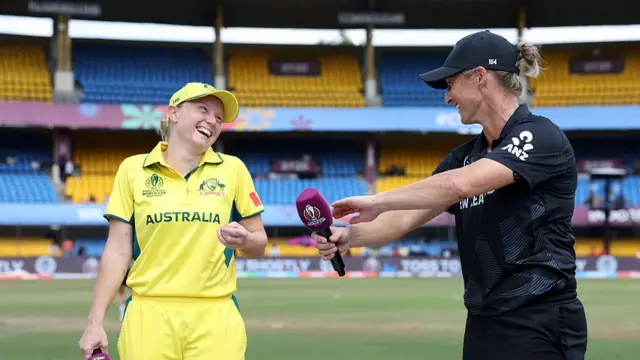 : Alyssa Healy of Australia shares a joke with Sophie Devine of New Zealand