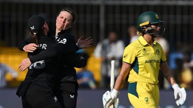 Lea Tahuhu of New Zealand celebrates with team mate Melie Kerr after taking the wicket of Beth Mooney of Australia