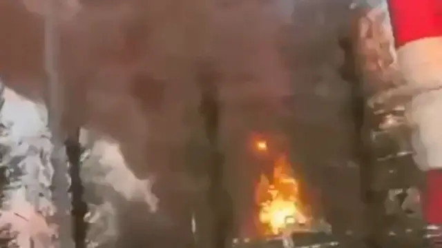 This screengrab shows a fire burning at the facility in Yaroslavl, a red and white striped chimney is visible next to a huge plume of smoke