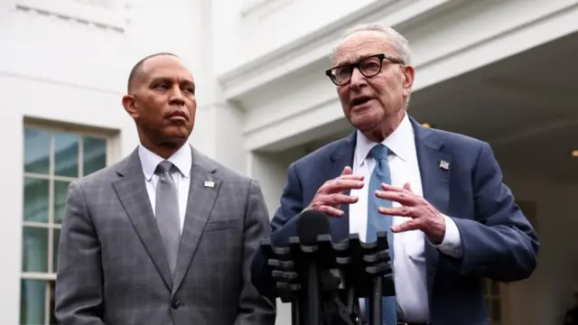 Two men in suits at a podium
