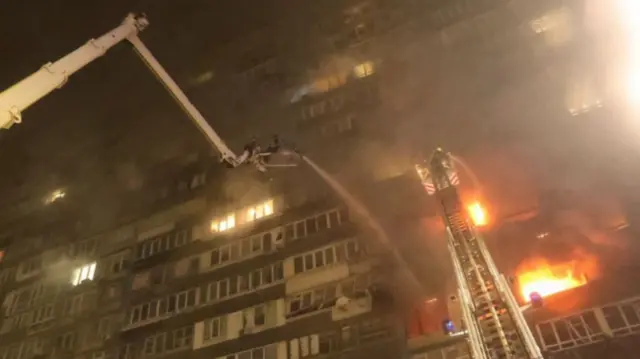 Firefighters tackle a blaze at an apartment building in Kyiv, Ukraine, 10 October 2025