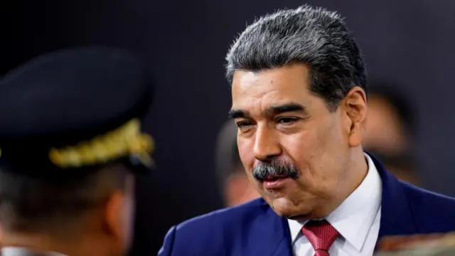 Venezuela's President Nicolas Maduro in a blue suit and red tie