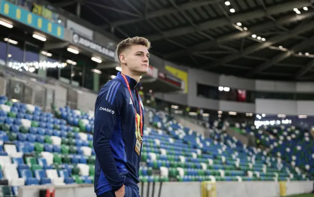 Justin Devenny walks onto the pitch