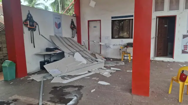 A large sheet is broken on the ground in a building