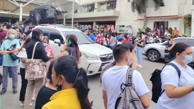 Staff and patients at the Southern Philippines Medical Center rush to evacuate
