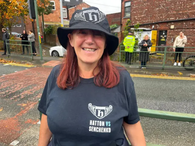 A mourner is standing outside Hatton's Gym