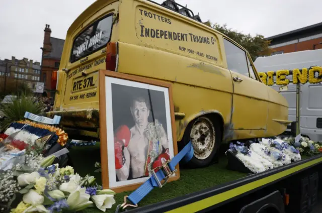 The yellow Reliant Regal on a flatbed truck