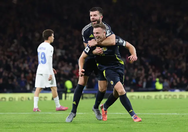 Scotland players celebrate beating Greece