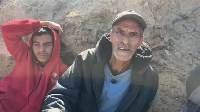 Wael Al-Najjar and his son face the camera