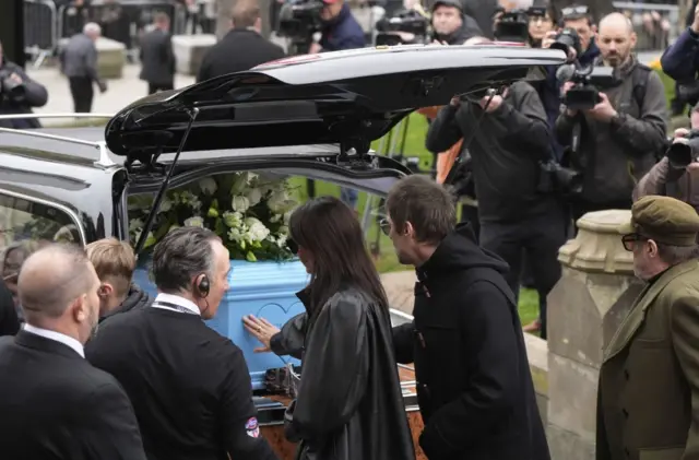 Liam Gallagher touches the coffin of Ricky Hatton at Manchester Cathedral.