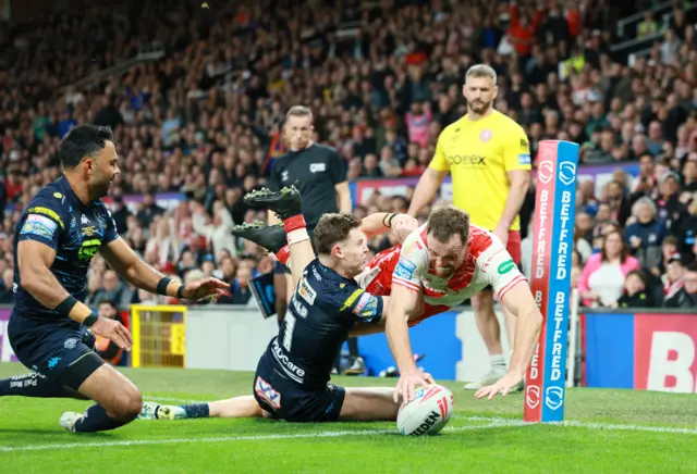 Joe Burgess dives in at the corner to score for Hull KR