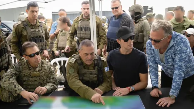 Witkoff and Kushner at a table looking at a map with military personnel.