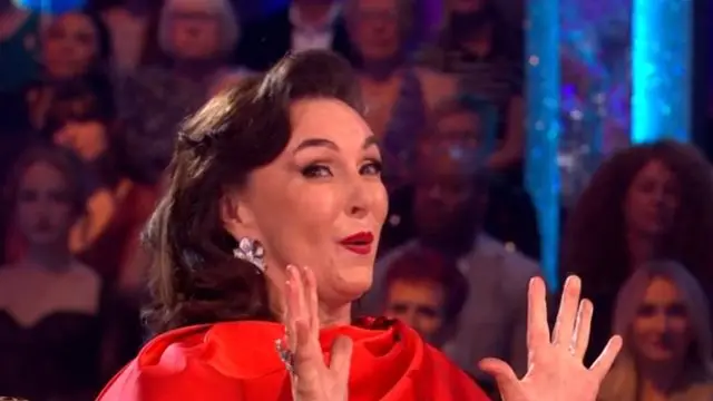 Shirley Ballas with her hands raised