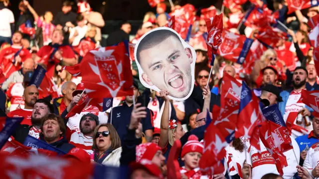 Hull KR fans with a cut-out image of Mikey Lewis