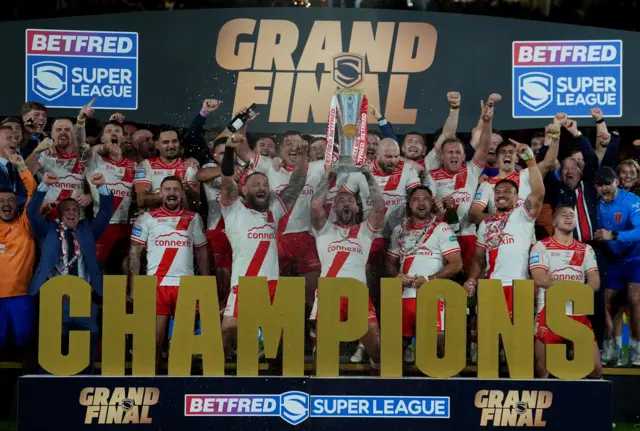 Elliot Minchella lifts the Super League trophy