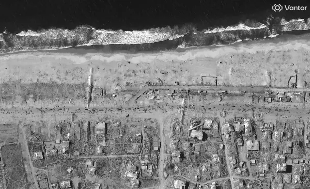 Infrared satellite image shows destroyed remains of buildings along Gaza's coastline.