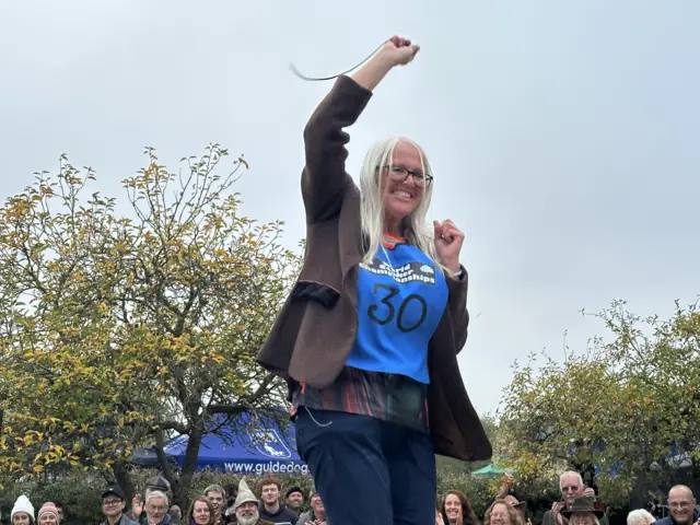 Woman celebrates on podium