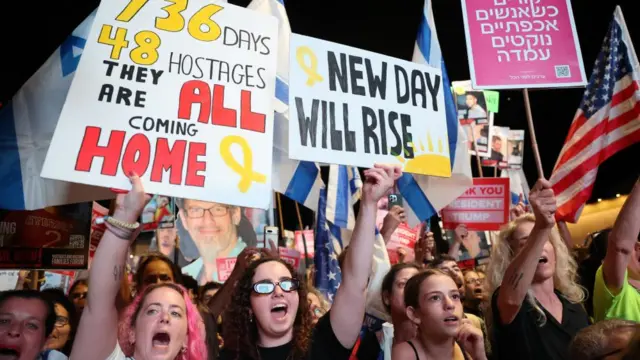 People celebrate during a rally at the so-called 'Hostages Square' outside the Kirya military headquarters in Tel Aviv, Israel,
