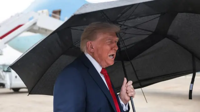 Trump under an umbrella